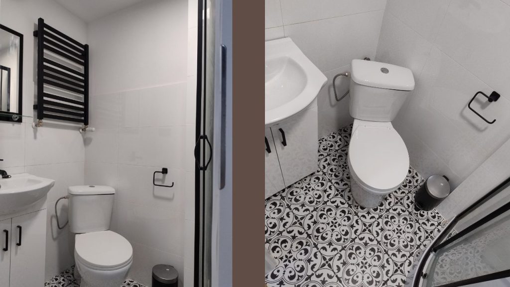 Łazienka w białych płytkach z kabiną prysznicową , szafką z umywalka i wc kompakt, dla kontrastu czarne dodatki i płytki typu patchwork na podłodze